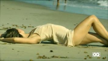 Olivia Wilde laying on sand