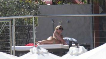 Abbey Clancy sunbathing topless