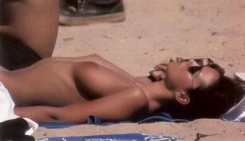 Monica Bellucci sunbathing topless