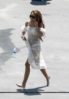 Miley Cyrus in nice transparent dress on the beach